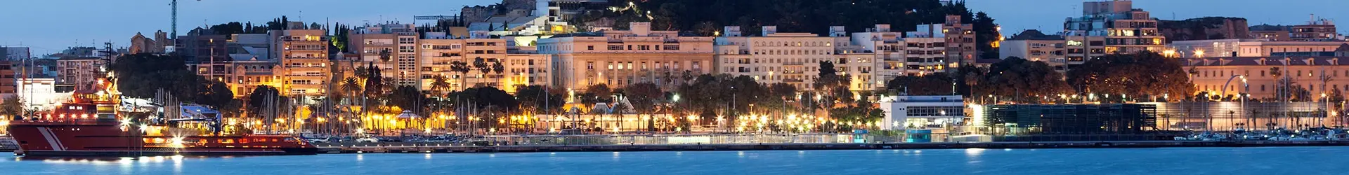 Port de Malaga en Andalousie la nuit, bâtiments historiques et front de mer éclairé